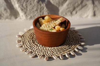 De raffia schelpvormige pannenonderzetter